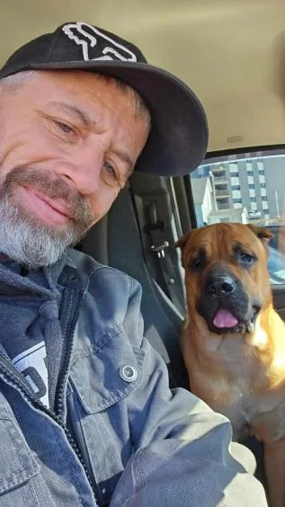 Joey Duchesne of JD Flooring with his dog, the Boss, in the work van