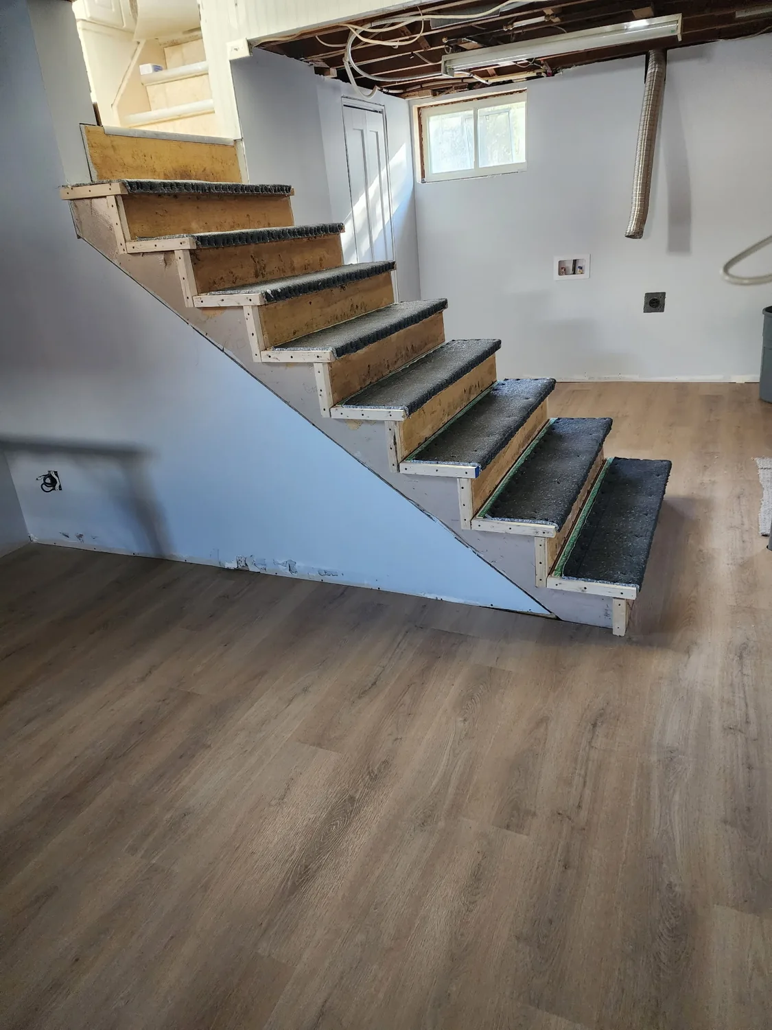 Open-riser wood stairs installed by JD Flooring in North Bay