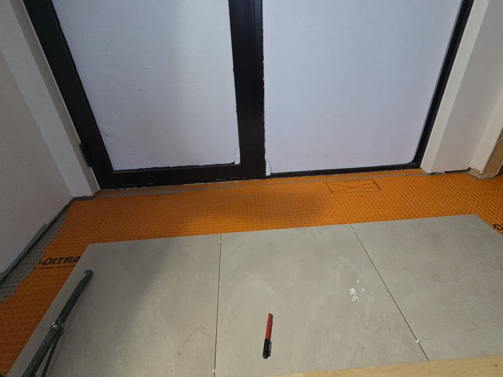 Large-format tile flooring installation over Ditra membrane