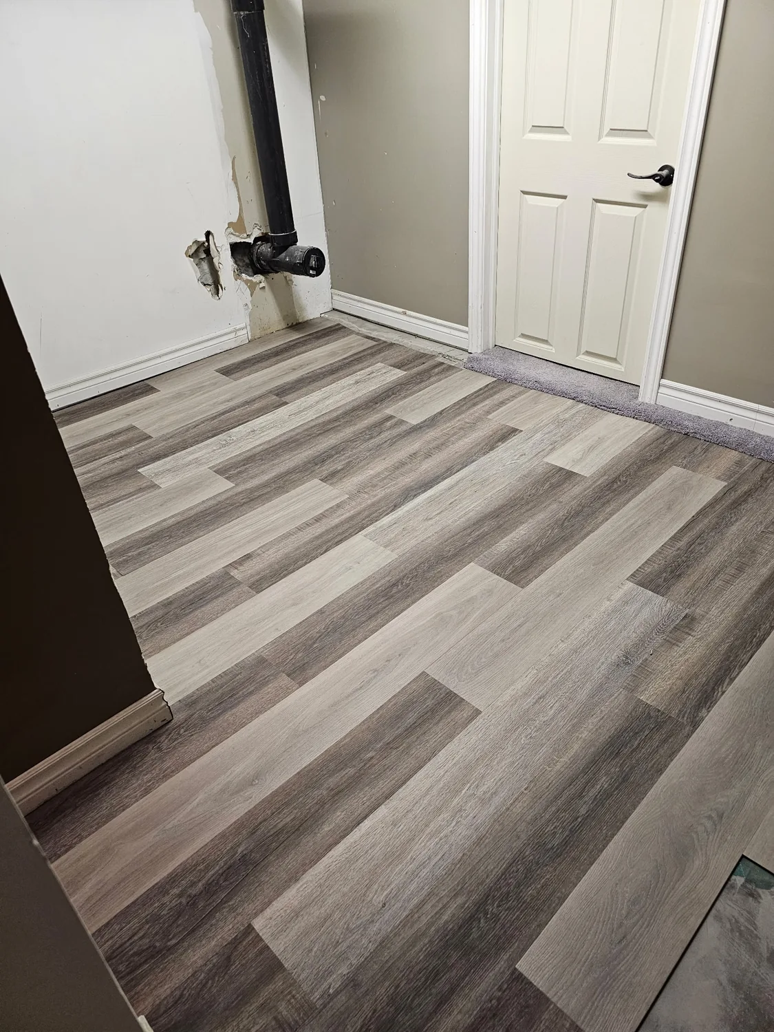 Grey vinyl plank flooring in a North Bay room installed by JD Flooring