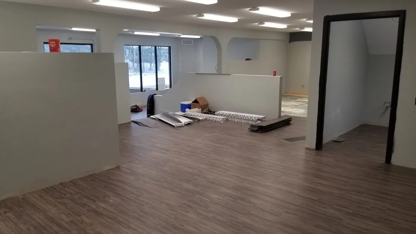 Wide-plank hardwood-look flooring in a North Bay commercial space by JD Flooring